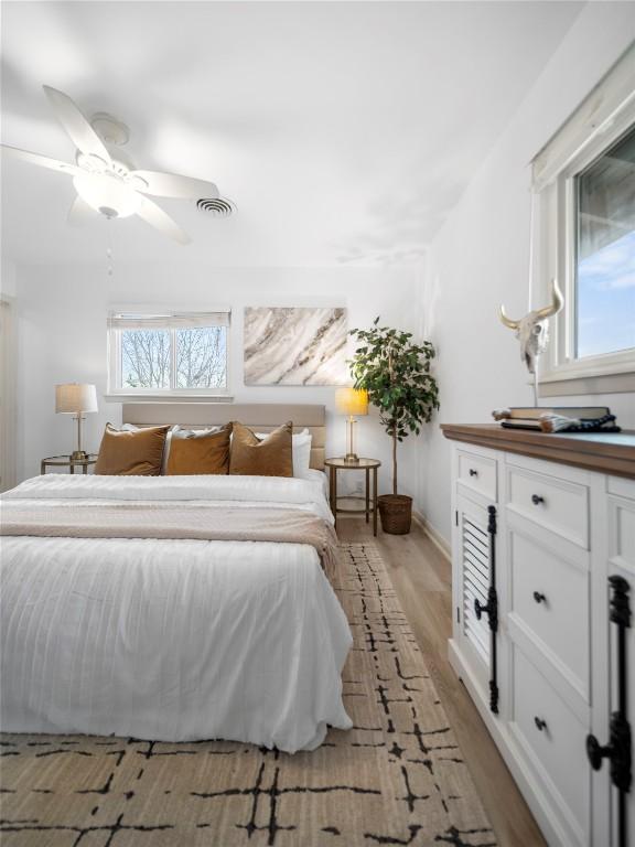 bedroom featuring ceiling fan and light hardwood / wood-style flooring