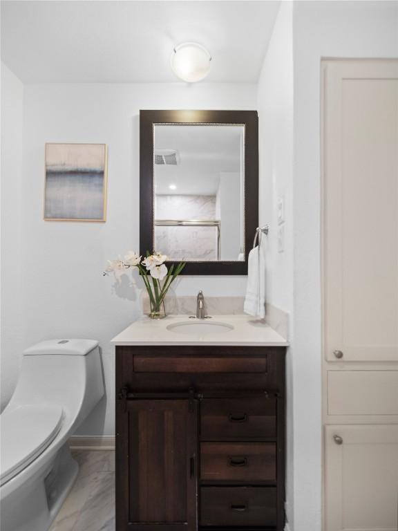 bathroom featuring vanity and toilet