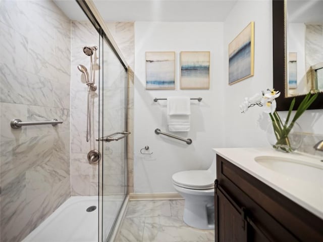 bathroom with vanity, toilet, and a shower with shower door