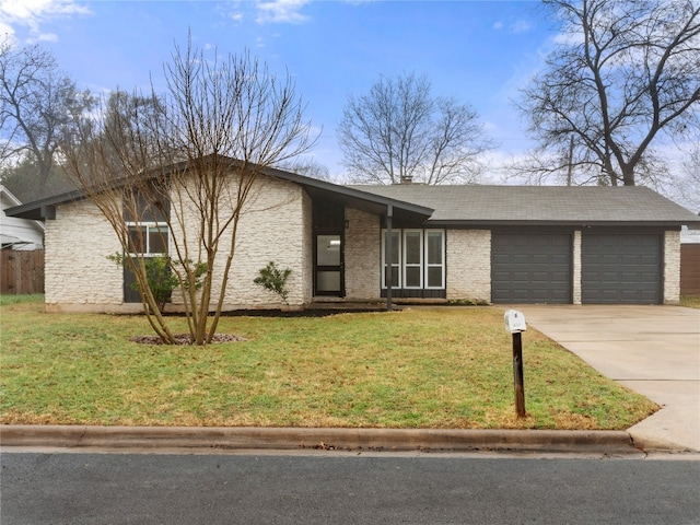 ranch-style home featuring a garage and a front yard