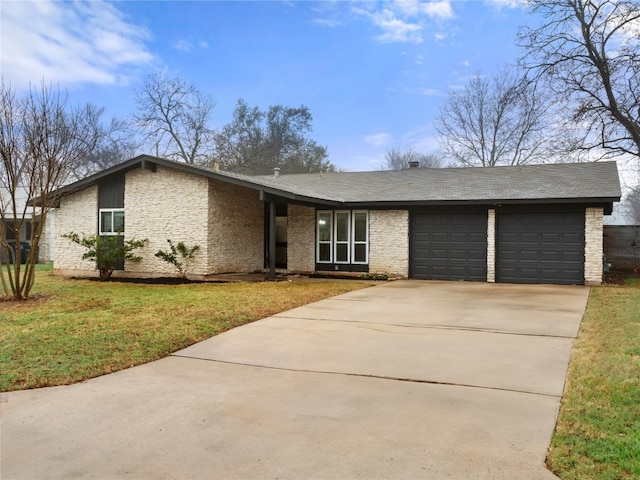 ranch-style home with a garage and a front lawn