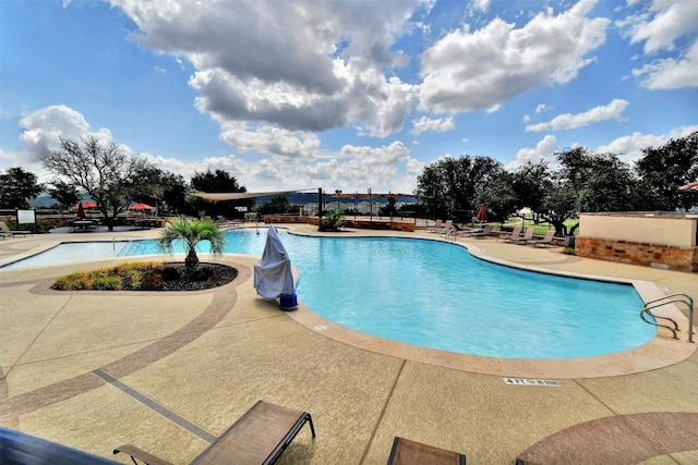 view of swimming pool featuring a patio area