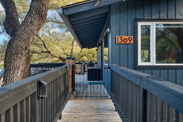 wooden deck featuring central AC unit