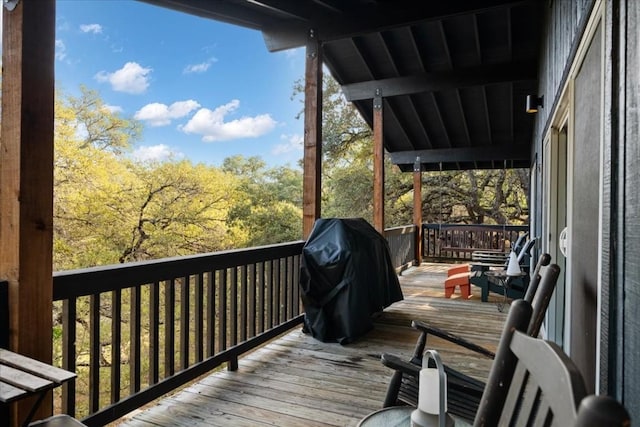 wooden terrace with a grill