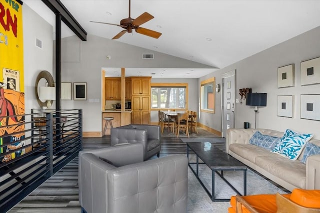 living room featuring ceiling fan and lofted ceiling