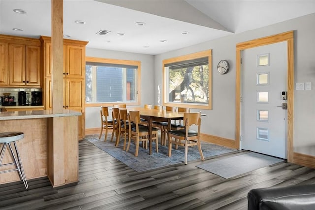 dining space with dark hardwood / wood-style flooring