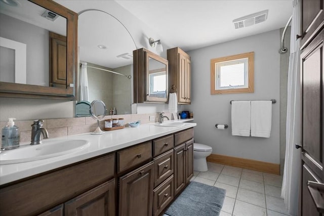 bathroom featuring tile patterned flooring, vanity, and toilet