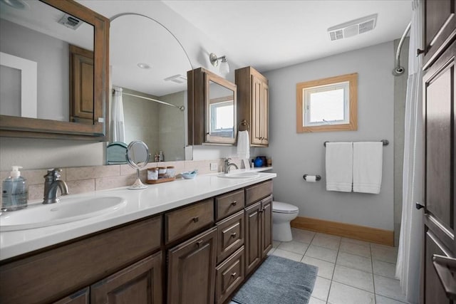 1309 Edgewater Dr, Spicewood, TX 78669 - bathroom with a shower with shower curtain, double vanity, toilet, tile patterned floors, and baseboards