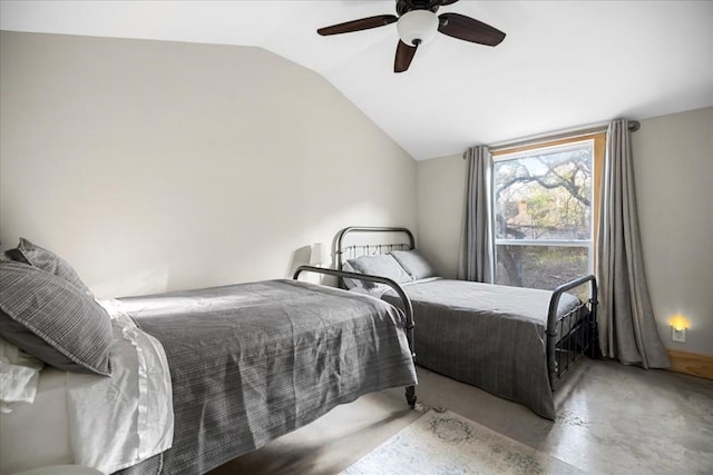 bedroom featuring ceiling fan, vaulted ceiling, and concrete floors