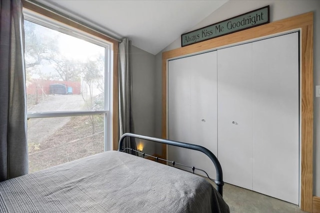 bedroom featuring vaulted ceiling and a closet