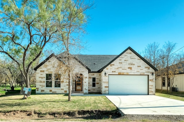 view of front of home featuring a garage, central AC, and a front yard