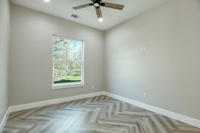 empty room featuring light parquet floors and ceiling fan