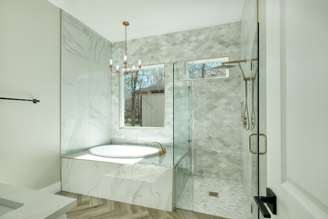 bathroom with vanity, a chandelier, and separate shower and tub