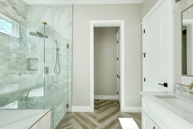 bathroom featuring vanity and a shower with door