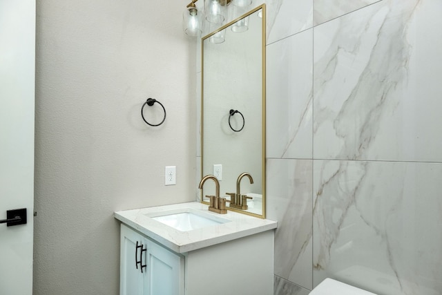 bathroom featuring vanity and toilet