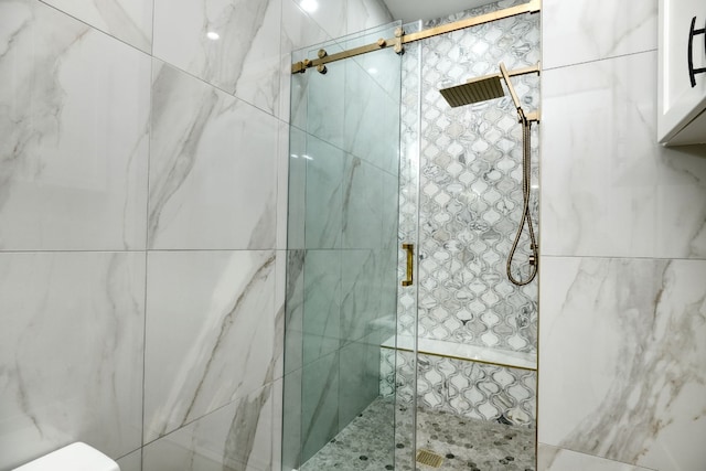 bathroom featuring a shower with door