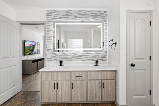 bathroom featuring vanity and decorative backsplash