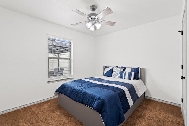 bedroom with ceiling fan and dark carpet