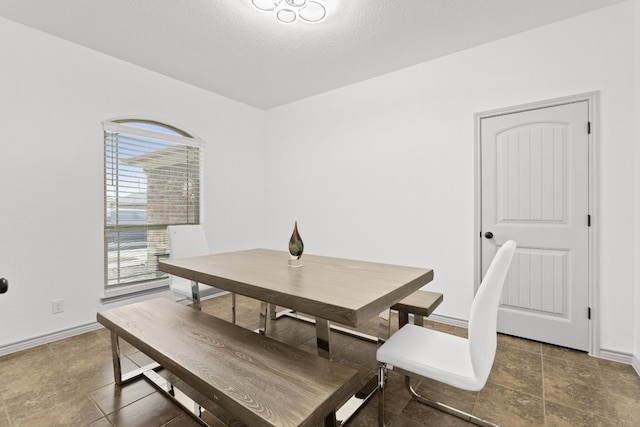 dining space with a textured ceiling