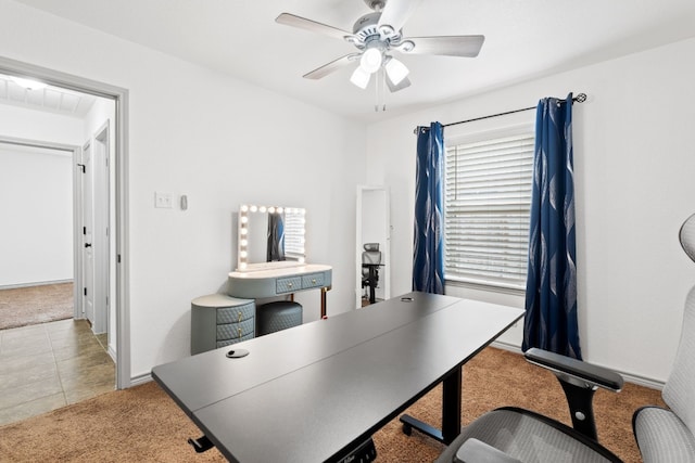 carpeted home office featuring ceiling fan