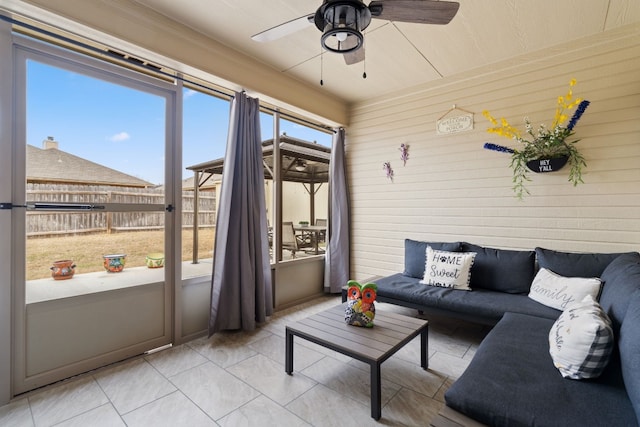 sunroom / solarium featuring ceiling fan