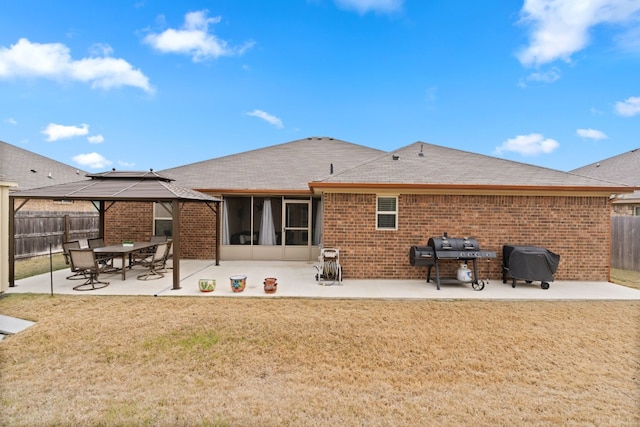 back of property featuring a gazebo, a lawn, and a patio