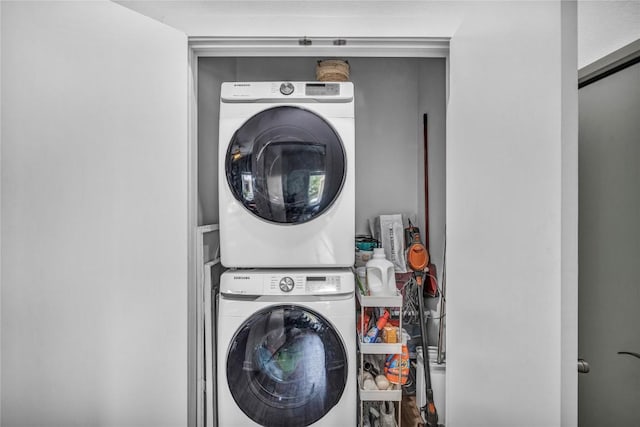 laundry area with laundry area and stacked washer / drying machine