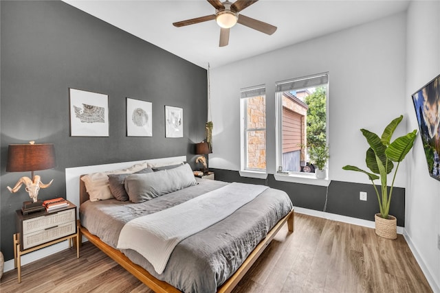 bedroom featuring hardwood / wood-style flooring and ceiling fan