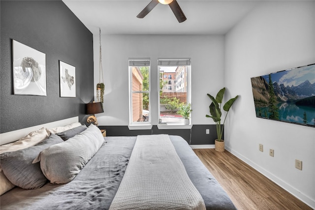 bedroom with hardwood / wood-style floors and ceiling fan