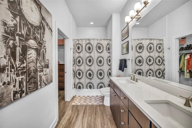 bathroom featuring vanity, hardwood / wood-style flooring, a shower with curtain, and toilet