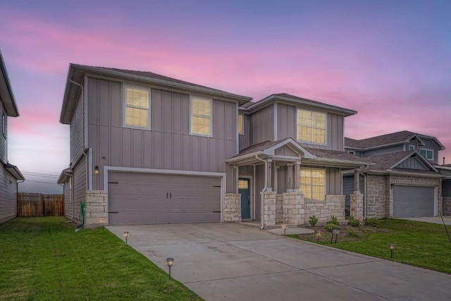 view of front of house featuring a yard and a garage