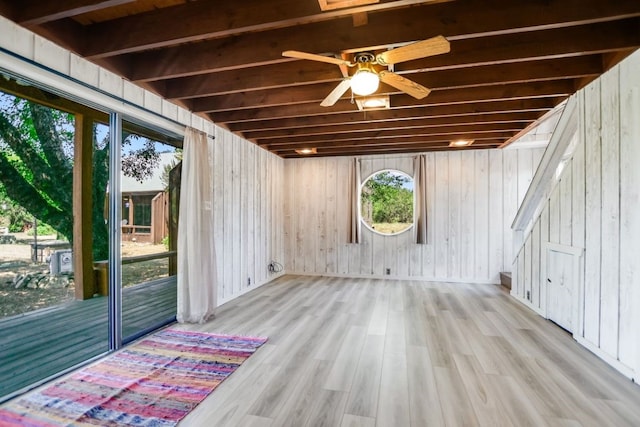 basement with ceiling fan and light wood-type flooring