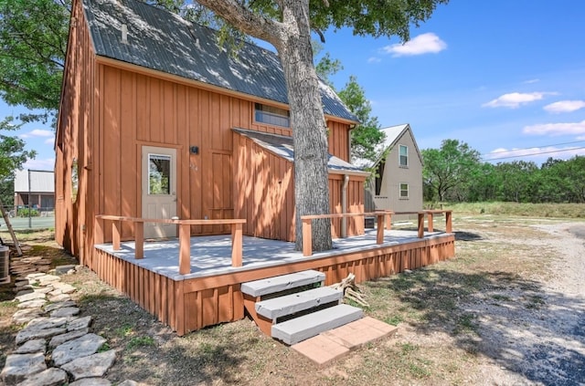 back of property featuring a wooden deck