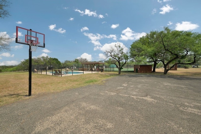 view of basketball court with a lawn