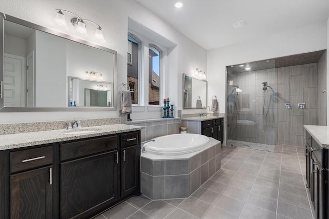 bathroom with shower with separate bathtub, tile patterned floors, and vanity