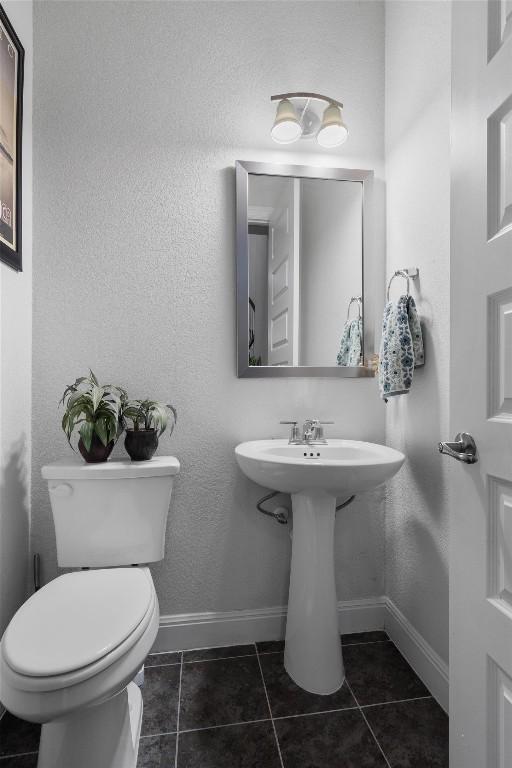 bathroom featuring sink, tile patterned floors, and toilet