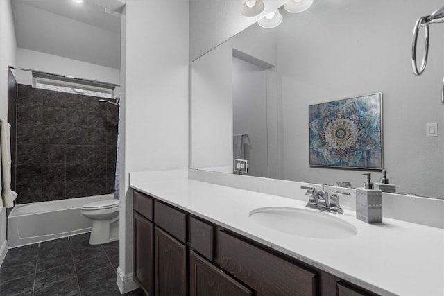 full bathroom featuring vanity, tiled shower / bath, tile patterned floors, and toilet