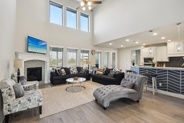 living room with light hardwood / wood-style floors and a tile fireplace