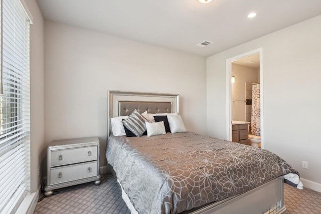 carpeted bedroom featuring ensuite bathroom