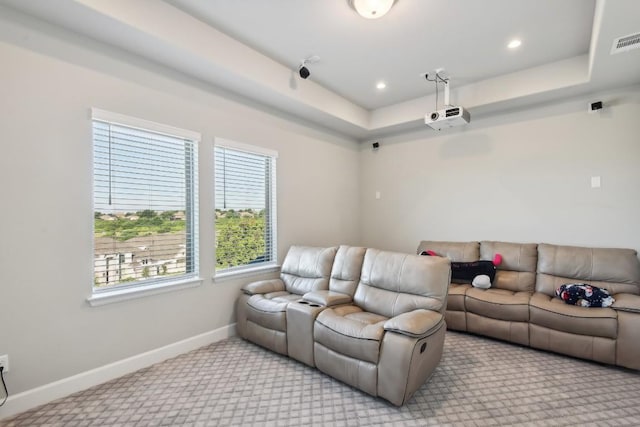 living room with light colored carpet and a tray ceiling