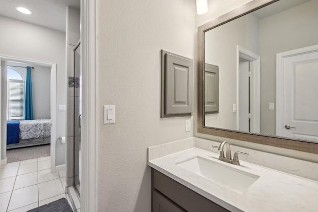 bathroom with tile patterned floors, vanity, and an enclosed shower