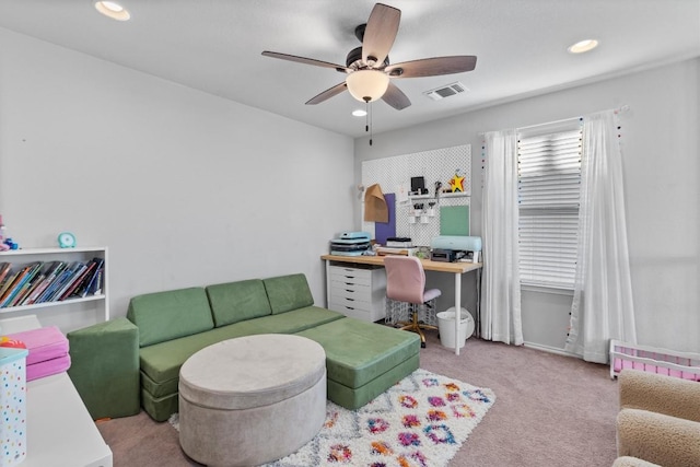 carpeted office space featuring ceiling fan