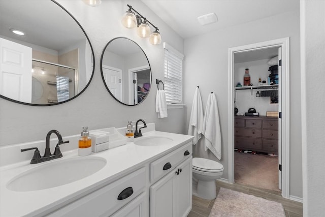 bathroom featuring vanity, hardwood / wood-style floors, and a shower with door