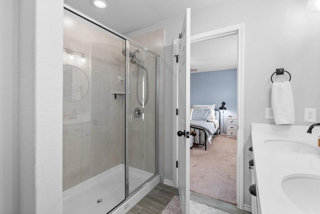 bathroom featuring vanity and a shower with shower door