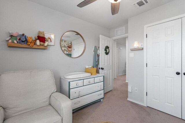 sitting room featuring ceiling fan and light carpet