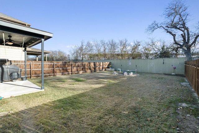 view of yard featuring a patio and ceiling fan