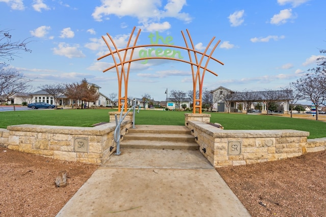 view of property's community with a lawn