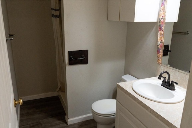 bathroom featuring vanity, hardwood / wood-style flooring, and toilet