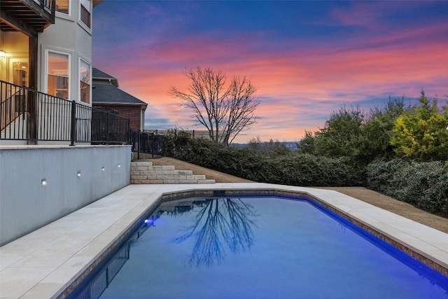 view of pool at dusk