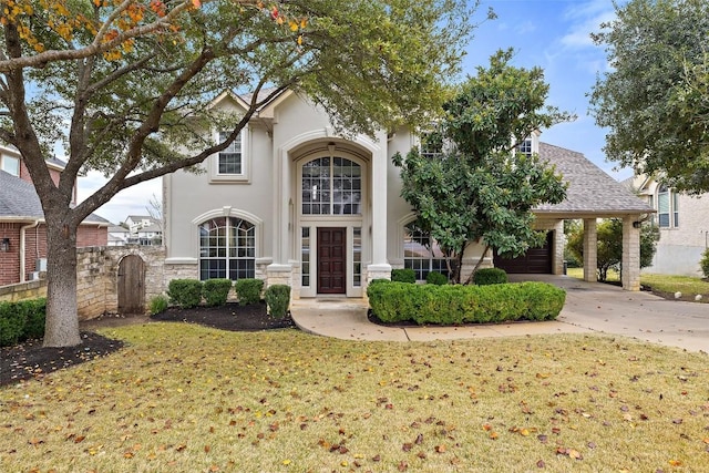 view of front of property with a carport and a front lawn